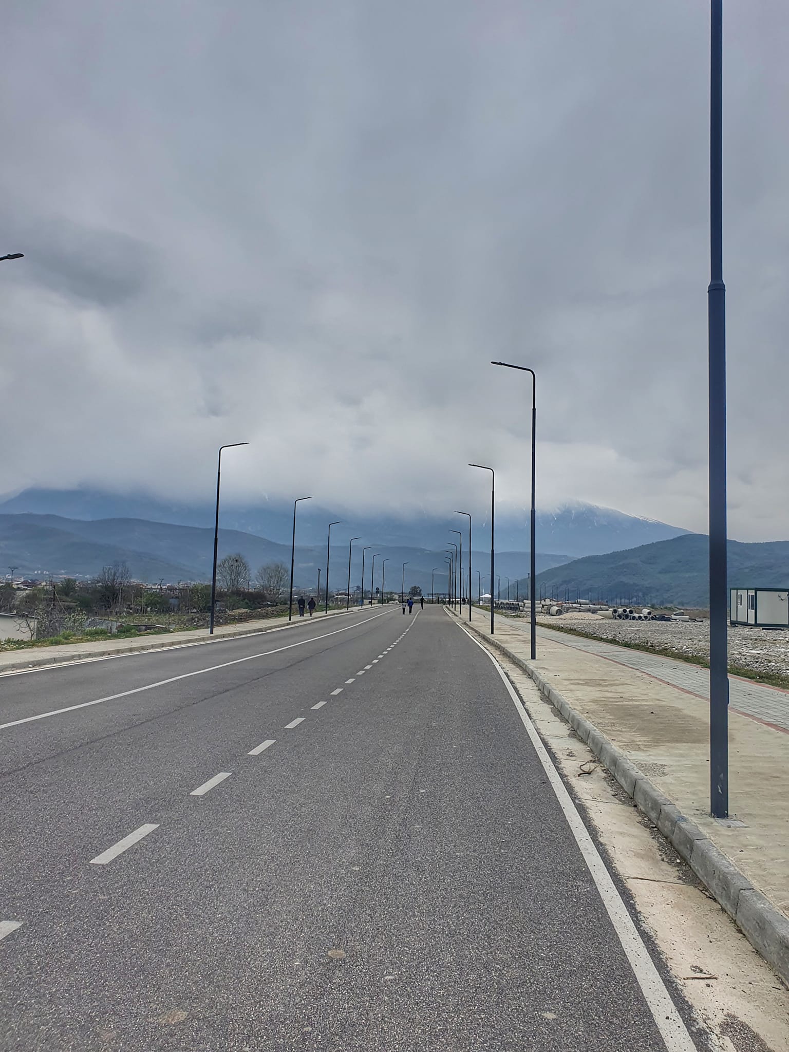 May be an image of 2 people, fog, road and cloud